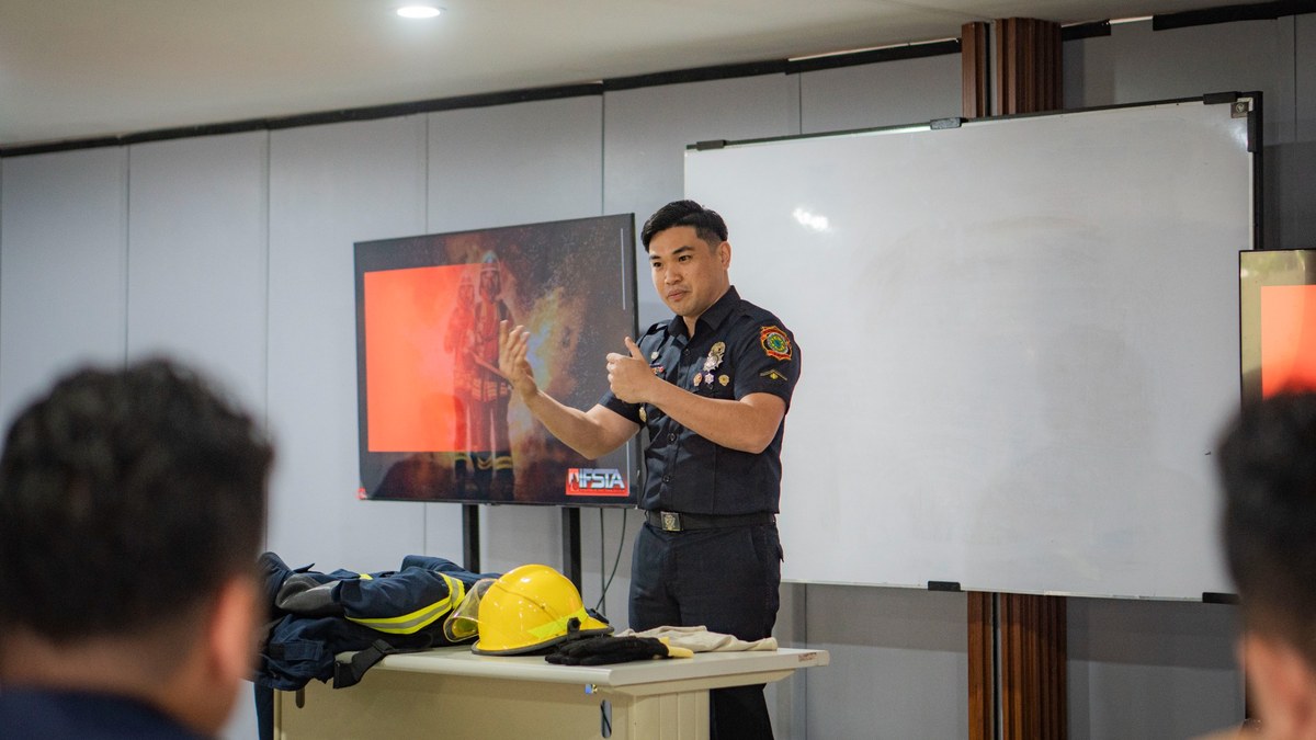 Participant reviewing a fire service instructor reference manual during guided study